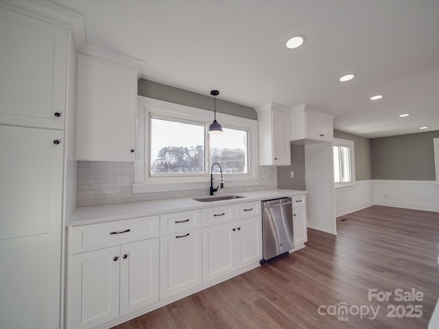 kitchen featuring dishwasher, tasteful backsplash, white cabinetry, and sink