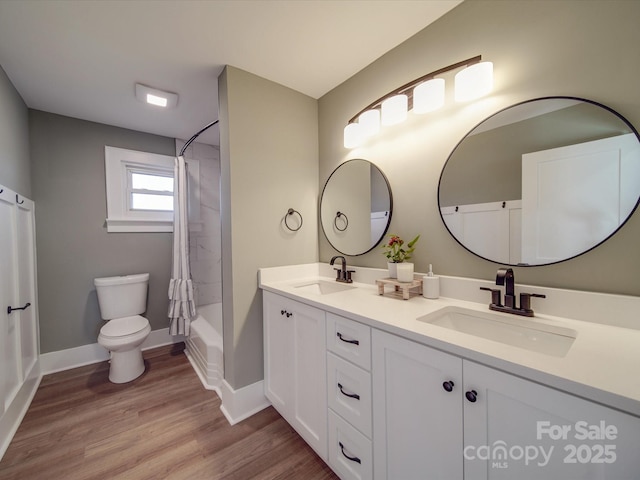 full bathroom featuring shower / bath combo, vanity, hardwood / wood-style flooring, and toilet