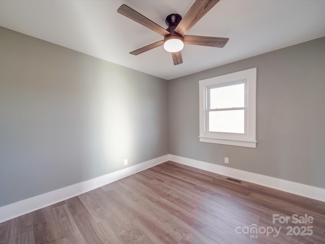 empty room featuring ceiling fan and light wood-type flooring