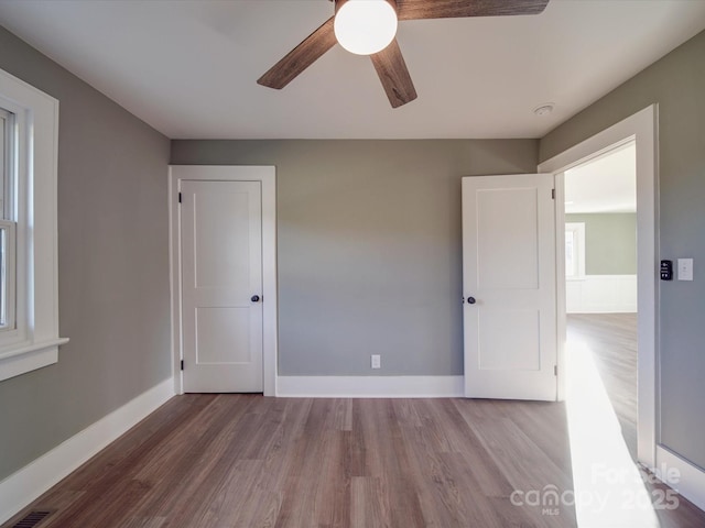 spare room with hardwood / wood-style floors and ceiling fan