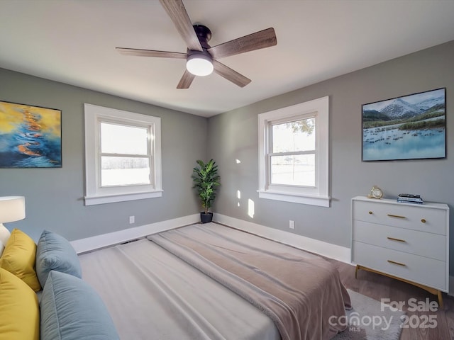 bedroom with hardwood / wood-style floors and ceiling fan