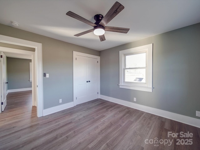 unfurnished bedroom featuring ceiling fan, light hardwood / wood-style floors, and a closet