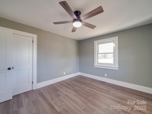 unfurnished bedroom with ceiling fan, a closet, and light hardwood / wood-style flooring