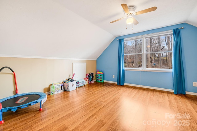 playroom with ceiling fan, hardwood / wood-style floors, and vaulted ceiling