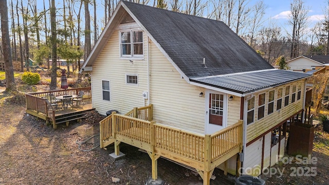 back of house with a sunroom, central AC unit, and a wooden deck