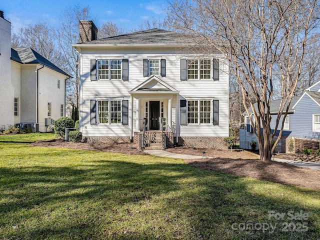 colonial house featuring a front yard