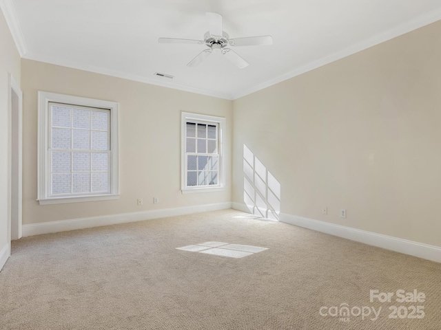 carpeted empty room with ceiling fan and ornamental molding