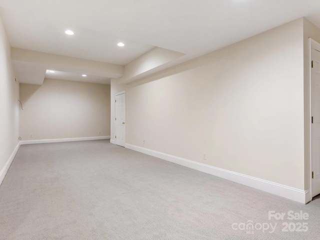 basement featuring light colored carpet