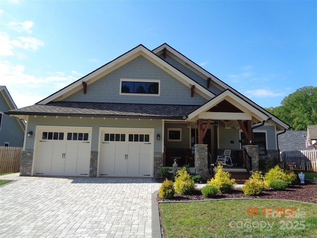 craftsman-style home with a garage and covered porch