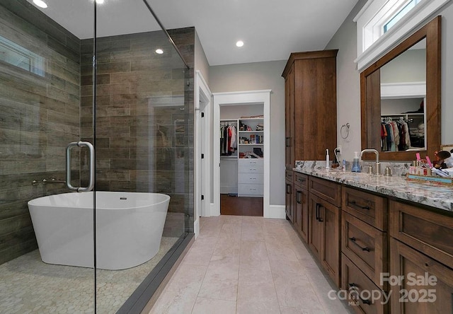 bathroom with tile patterned flooring, vanity, and shower with separate bathtub