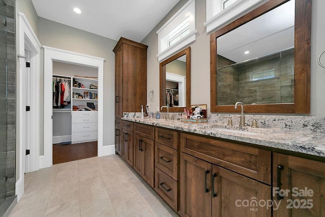 bathroom with vanity, tile patterned flooring, and a shower with door