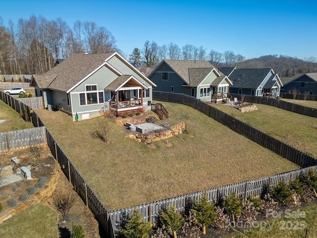 view of front facade with a deck and a front lawn