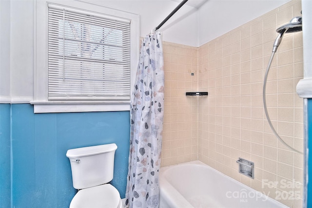 bathroom featuring toilet and shower / bathtub combination with curtain