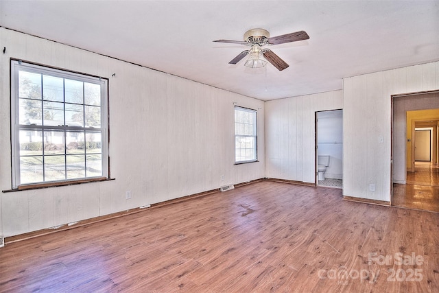 empty room featuring ceiling fan and light hardwood / wood-style flooring