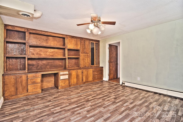 unfurnished living room with built in desk, a textured ceiling, ceiling fan, and built in shelves