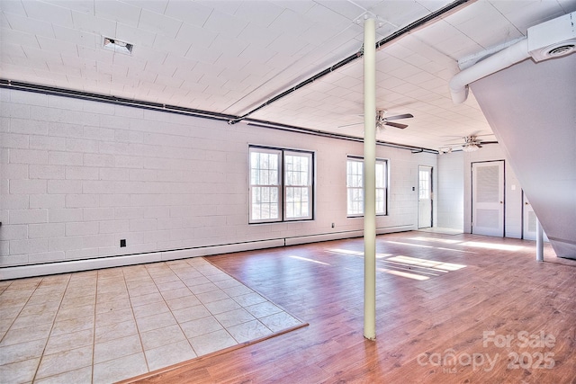 spare room with a baseboard radiator and hardwood / wood-style floors