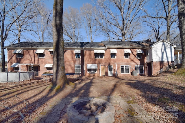 back of house featuring a fire pit