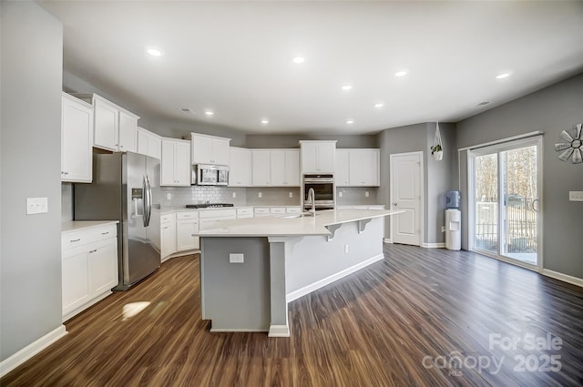 kitchen featuring white cabinets, a center island with sink, and appliances with stainless steel finishes