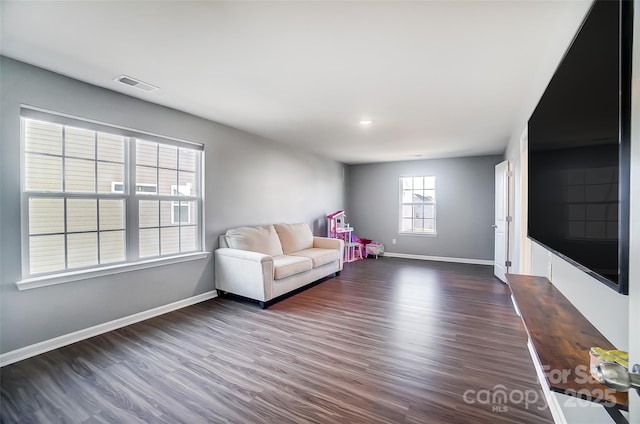 unfurnished living room featuring dark wood-type flooring