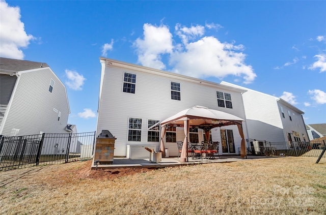 back of house featuring a gazebo, a yard, and a patio