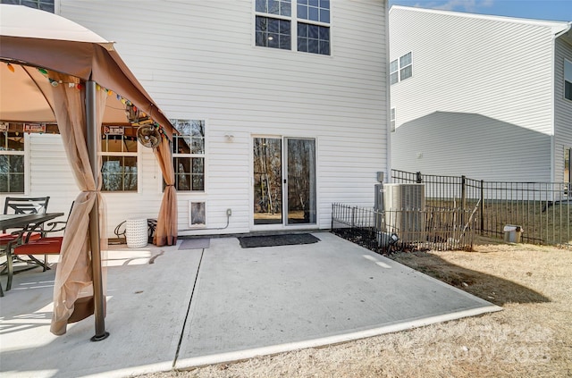 rear view of house with cooling unit and a patio