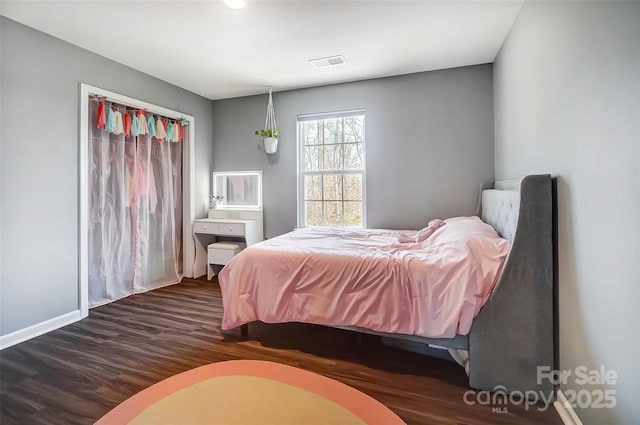 bedroom with dark hardwood / wood-style flooring