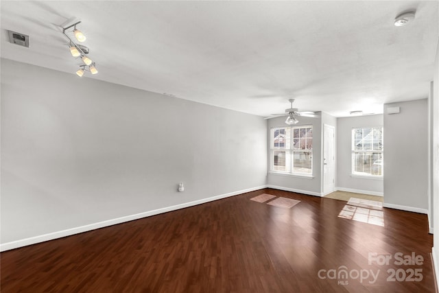 spare room with ceiling fan and dark hardwood / wood-style flooring