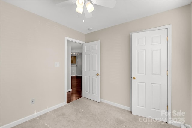 unfurnished bedroom with ceiling fan and light carpet