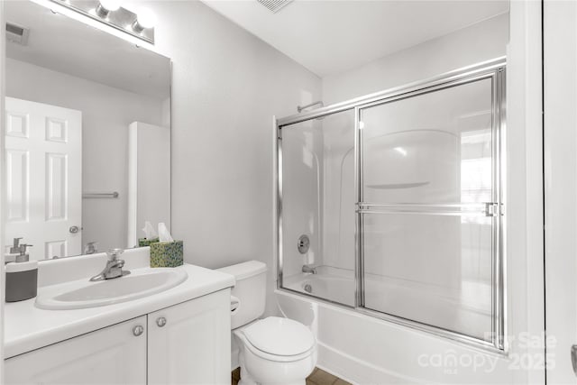 full bathroom featuring vanity, toilet, and enclosed tub / shower combo