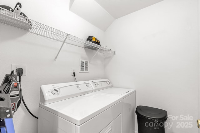 clothes washing area with separate washer and dryer