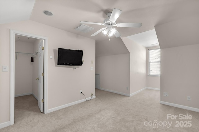 additional living space featuring ceiling fan, light colored carpet, and lofted ceiling