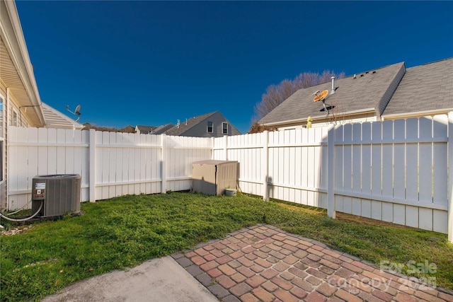 view of yard with a patio area and central air condition unit