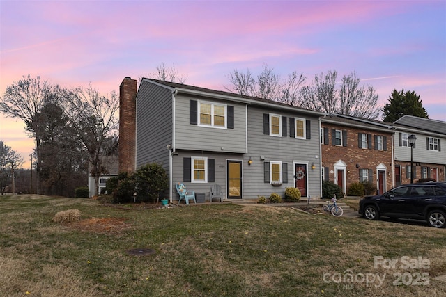 view of front of property with a yard