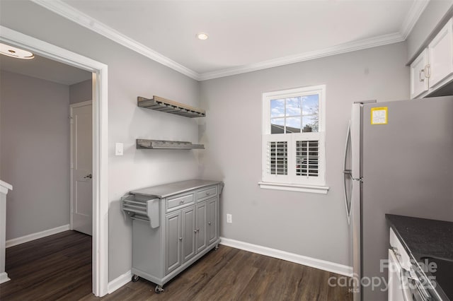 interior space featuring dark wood-type flooring, stainless steel fridge, white cabinetry, and ornamental molding