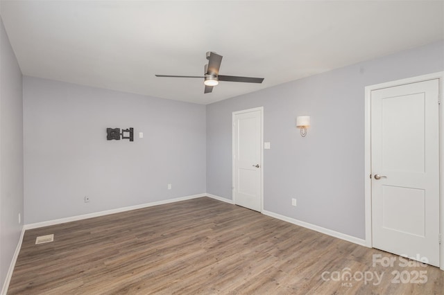 spare room featuring hardwood / wood-style flooring and ceiling fan