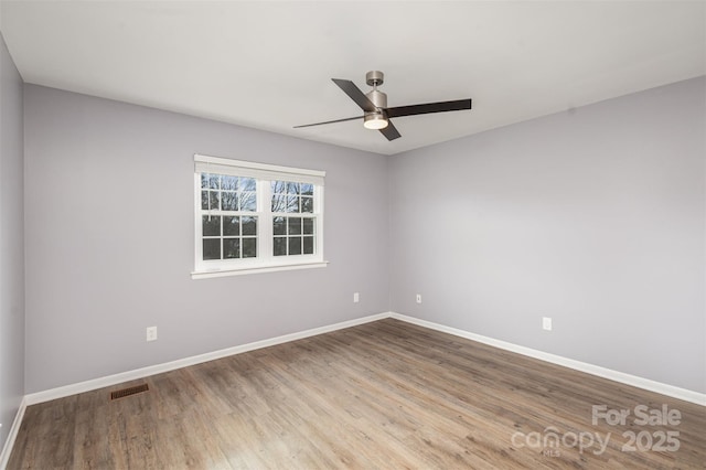 spare room featuring ceiling fan and hardwood / wood-style flooring