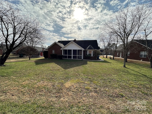 rear view of house with a lawn