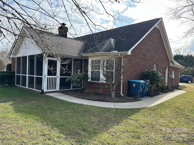 view of front of property featuring a sunroom and a front lawn