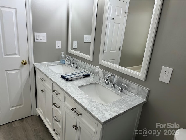 bathroom featuring vanity and hardwood / wood-style flooring