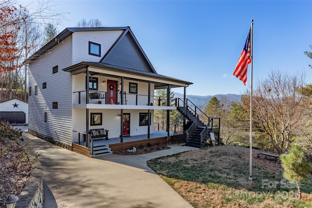 view of front facade with covered porch and a mountain view