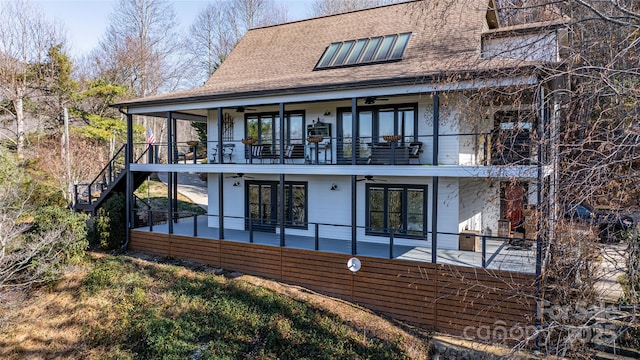 rear view of house featuring a balcony and a patio area