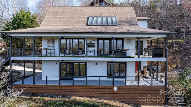 rear view of house featuring a patio area, ceiling fan, and a balcony