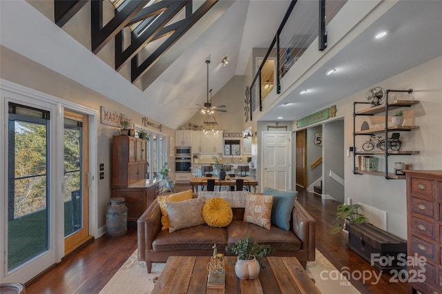 living room with high vaulted ceiling, ceiling fan, and dark wood-type flooring