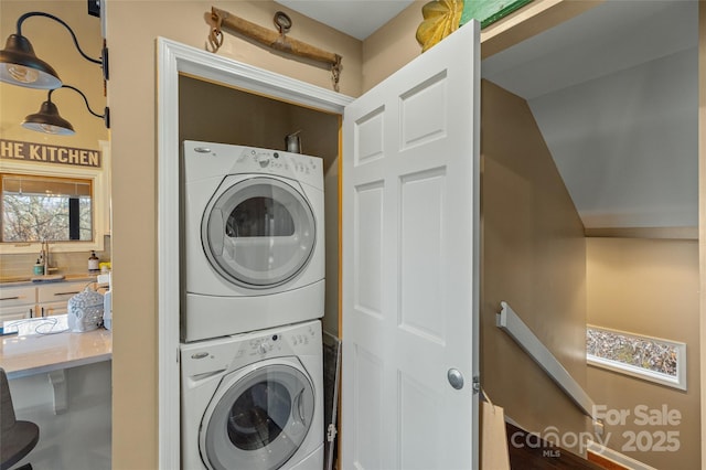 clothes washing area featuring stacked washer / dryer