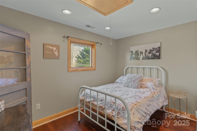 bedroom with dark hardwood / wood-style floors