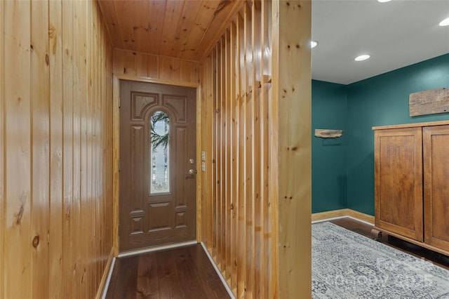 doorway to outside with wood walls, hardwood / wood-style floors, and wooden ceiling