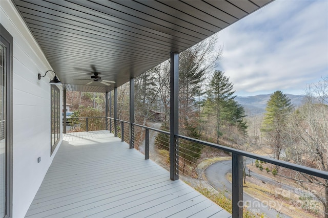 deck with ceiling fan and a mountain view