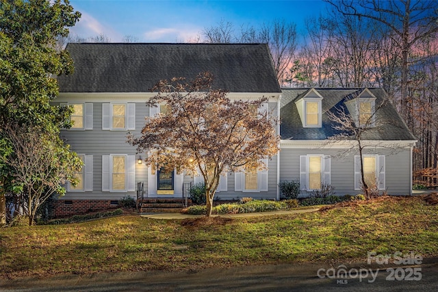 view of front of house with a yard