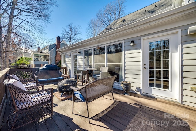 wooden deck with an outdoor fire pit