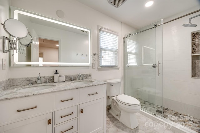 bathroom featuring walk in shower, tile patterned floors, vanity, and toilet